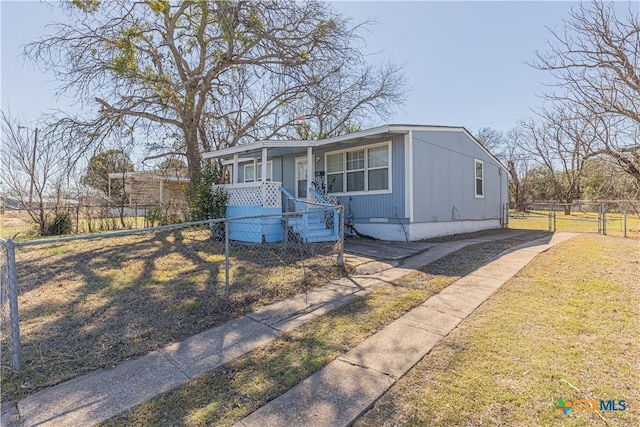 view of front of house featuring a fenced front yard, covered porch, and a front lawn