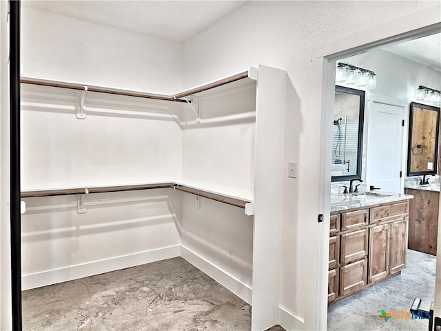 spacious closet featuring sink