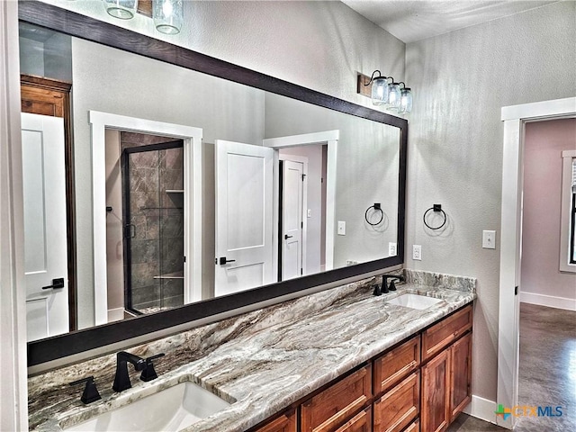 bathroom with vanity and tiled shower