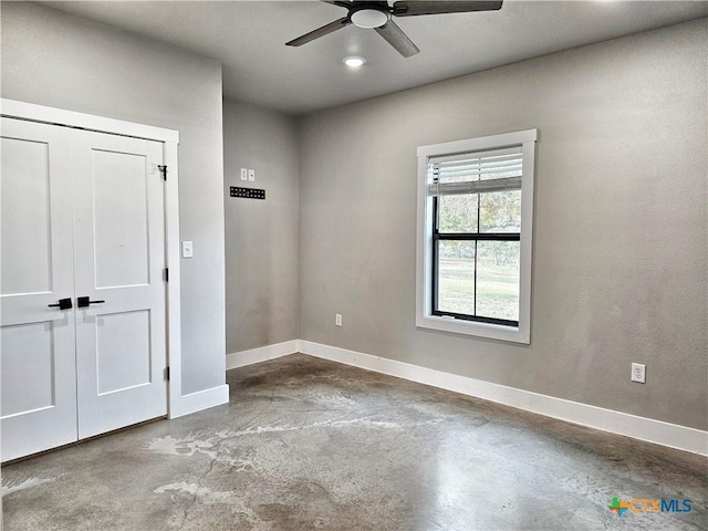 unfurnished room featuring concrete flooring and ceiling fan