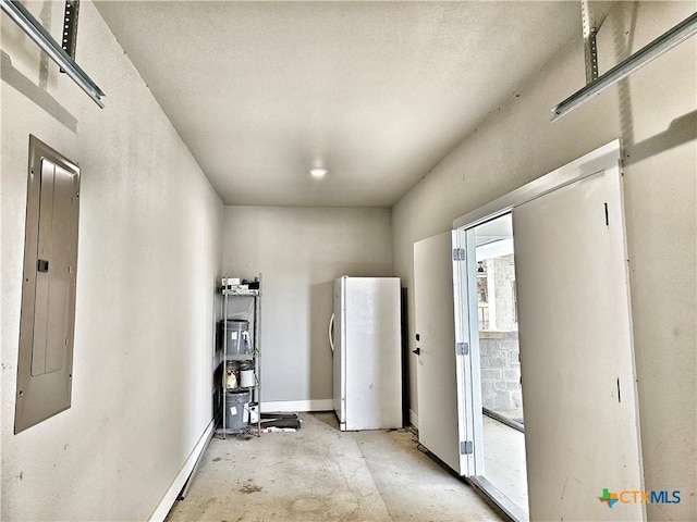 spare room with electric panel and baseboards