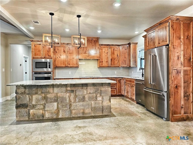 kitchen with decorative backsplash, appliances with stainless steel finishes, pendant lighting, an inviting chandelier, and a kitchen island