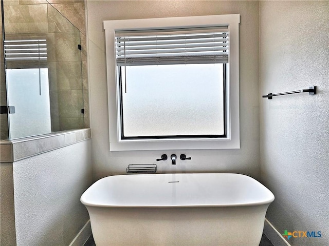 bathroom featuring plus walk in shower