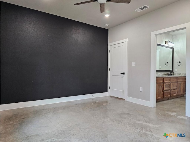 empty room featuring ceiling fan and sink