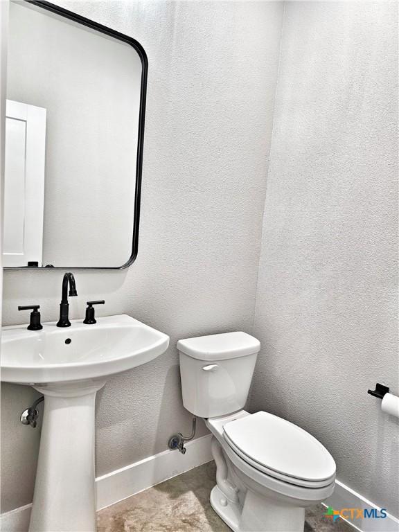 bathroom with toilet and sink