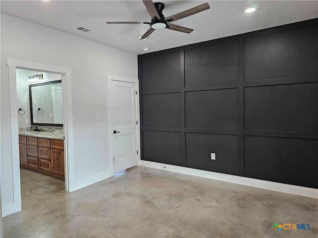 unfurnished bedroom featuring connected bathroom, ceiling fan, and sink