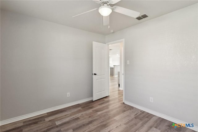 unfurnished room with ceiling fan and hardwood / wood-style floors