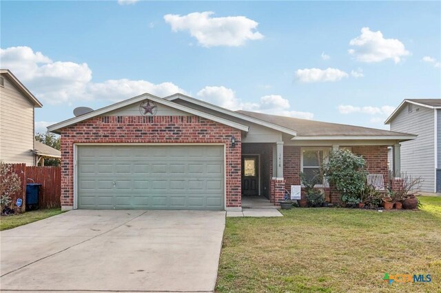 view of front of property with a front yard and a garage