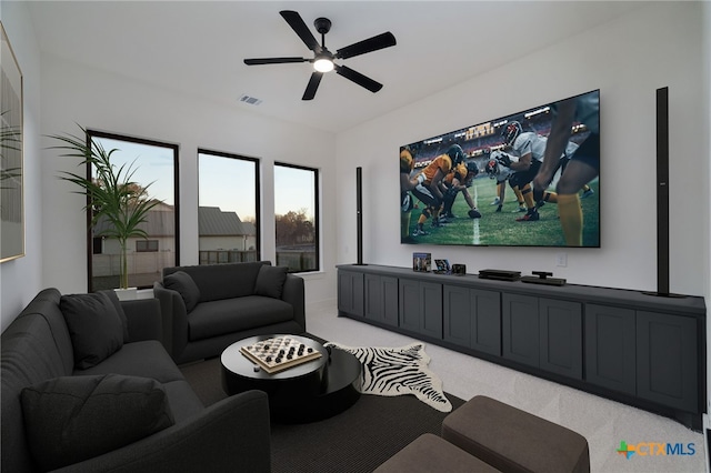 living area featuring a ceiling fan, light colored carpet, and visible vents