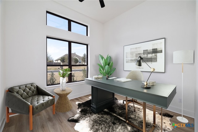 office with a ceiling fan, baseboards, and wood finished floors