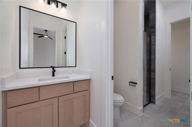 full bath with vanity, a ceiling fan, a shower stall, tile patterned floors, and toilet