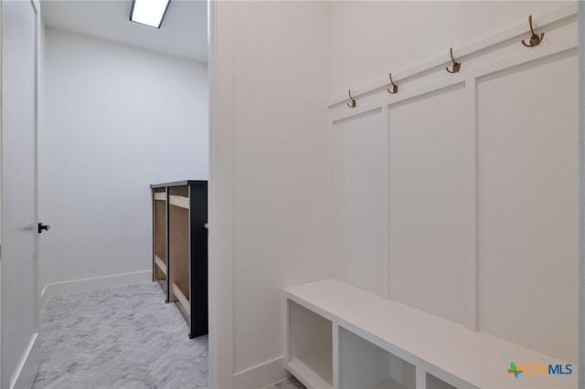 mudroom with a decorative wall