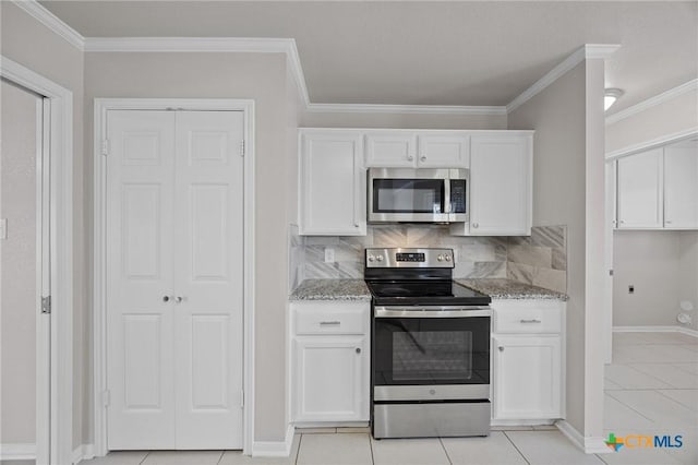 kitchen featuring light stone countertops, tasteful backsplash, white cabinetry, and stainless steel appliances