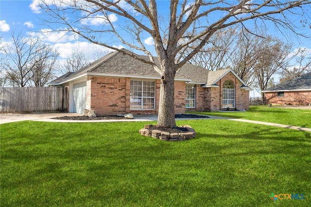 single story home featuring a garage, driveway, fence, a front lawn, and brick siding