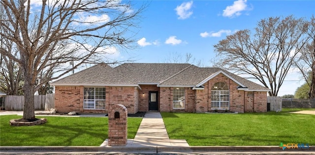 single story home with a front yard, brick siding, fence, and roof with shingles