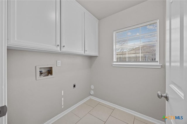 laundry area with light tile patterned floors, hookup for a washing machine, cabinet space, hookup for an electric dryer, and baseboards