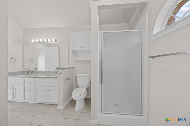 full bathroom featuring double vanity, a stall shower, toilet, tile patterned flooring, and a sink