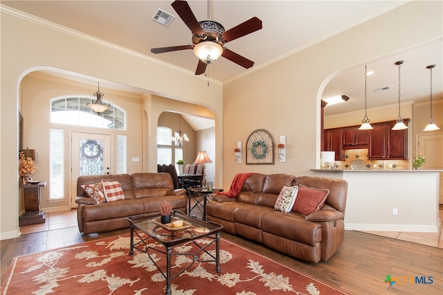 living room featuring hardwood / wood-style floors, a healthy amount of sunlight, and ornamental molding