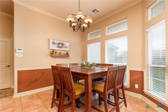 dining area with light tile patterned floors and crown molding