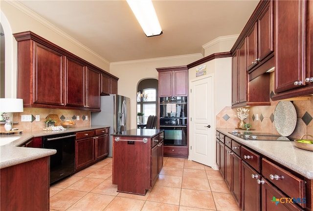 kitchen with black appliances, light tile patterned flooring, crown molding, and a center island