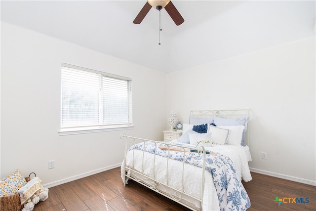 bedroom with dark hardwood / wood-style flooring and ceiling fan