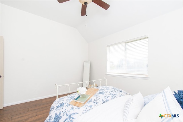 bedroom featuring dark wood-type flooring, ceiling fan, and vaulted ceiling