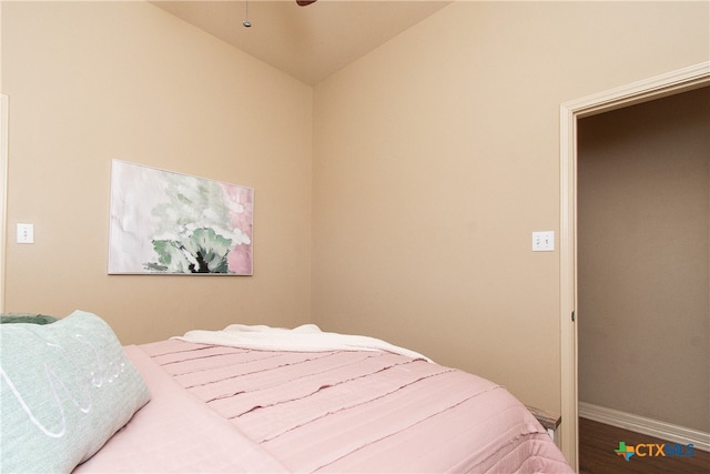 bedroom with wood-type flooring and lofted ceiling