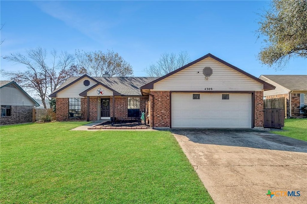 ranch-style home with a garage, a front lawn, concrete driveway, and brick siding