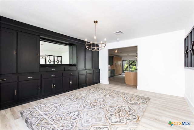 dining room featuring light hardwood / wood-style flooring and a chandelier