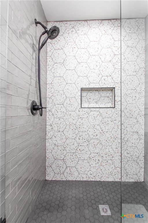 bathroom with tiled shower