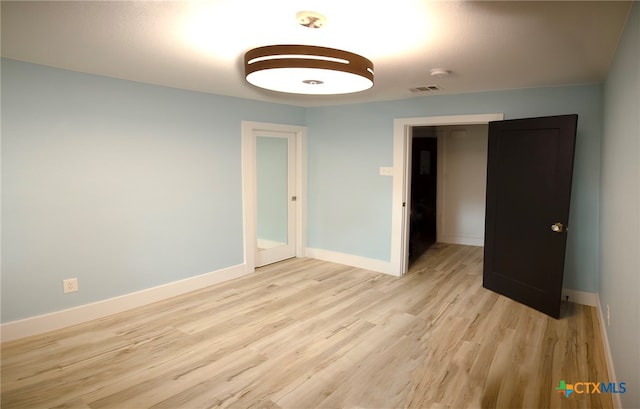 unfurnished bedroom featuring light wood-type flooring