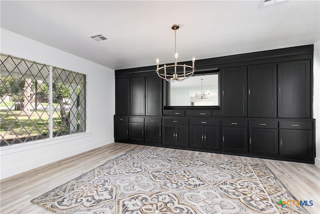 dining space featuring a notable chandelier and light hardwood / wood-style floors