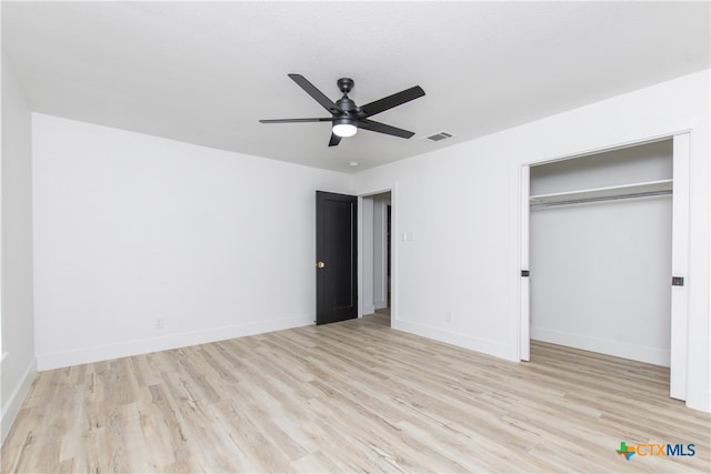 unfurnished bedroom with ceiling fan, a closet, and light wood-type flooring