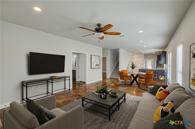 living room with dark wood-type flooring and ceiling fan