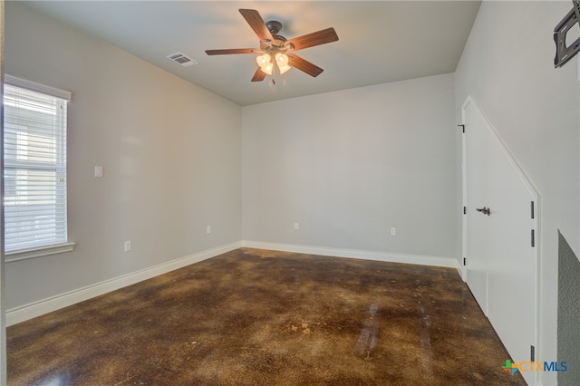 unfurnished room with dark carpet and ceiling fan