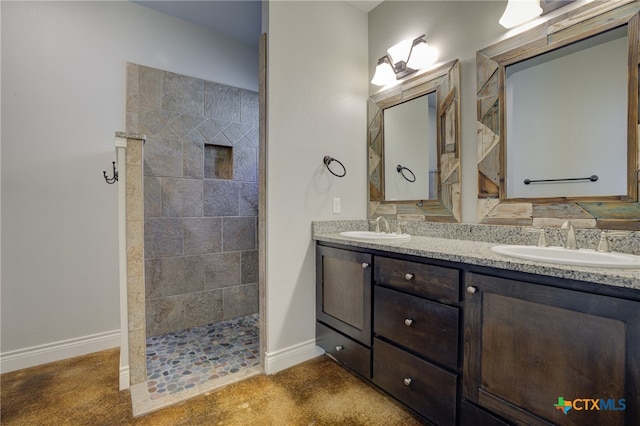 bathroom with vanity and a tile shower