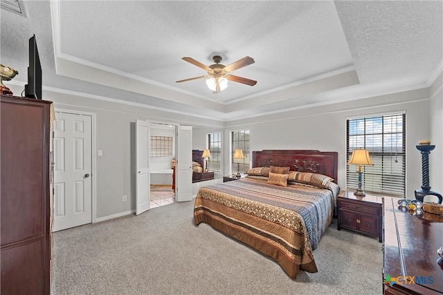 bedroom with crown molding, light colored carpet, a raised ceiling, and a textured ceiling