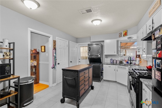 kitchen featuring white cabinetry, tasteful backsplash, black appliances, and a textured ceiling