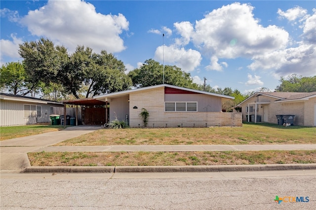 single story home with a front lawn and a carport