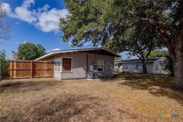 back of house with a lawn