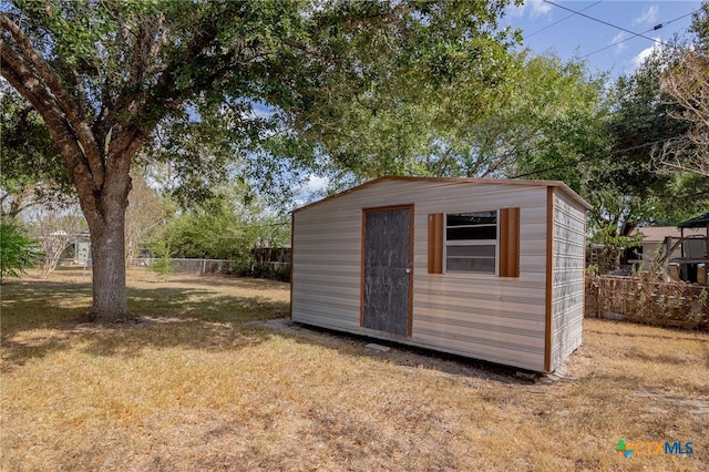 view of outbuilding with a yard