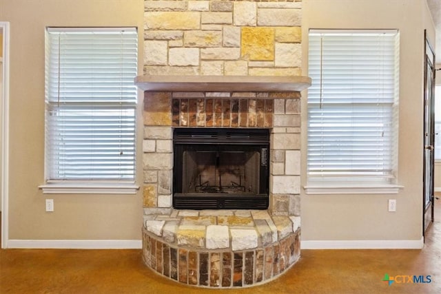 room details with a fireplace, carpet, and baseboards