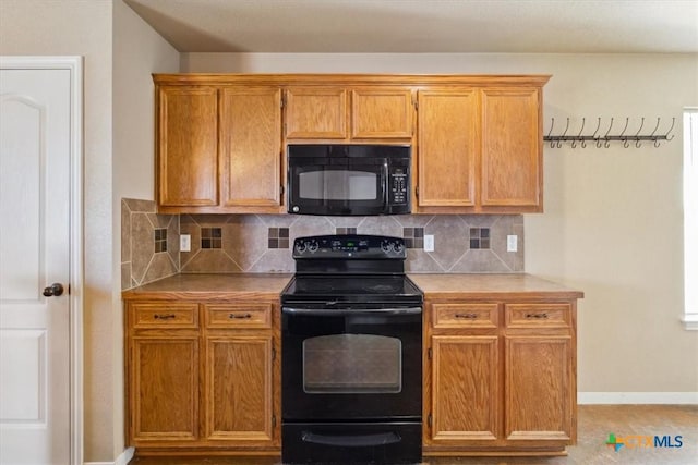 kitchen featuring brown cabinetry, baseboards, black appliances, light countertops, and tasteful backsplash