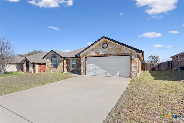 ranch-style home featuring driveway, a front lawn, stone siding, fence, and a garage