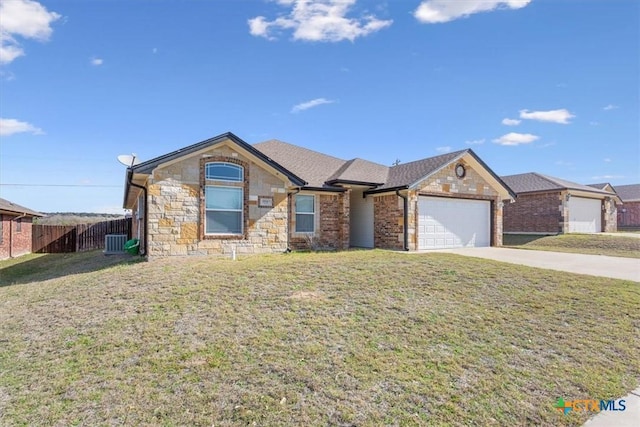 single story home with a front lawn, fence, concrete driveway, stone siding, and an attached garage