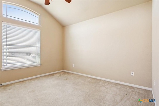 carpeted spare room with baseboards, lofted ceiling, and ceiling fan