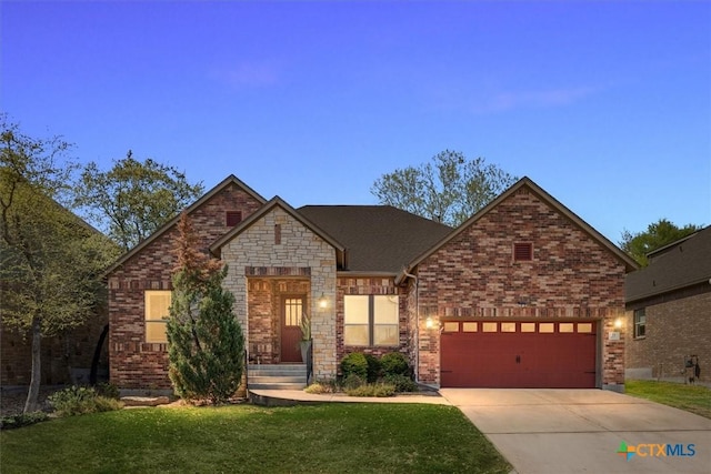 9550 Savannah Ridge Dr Unit 11, Austin, TX 78726 - view of front facade with concrete driveway, a front lawn, a garage, and brick siding