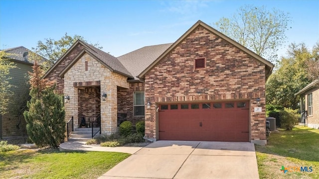 9550 Savannah Ridge Dr Unit 11, Austin, TX 78726 - view of front of property featuring a garage, driveway, brick siding, and a front lawn