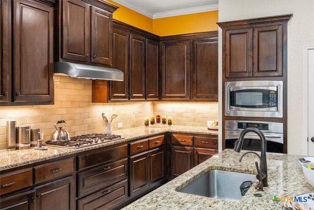 9550 Savannah Ridge Dr Unit 11, Austin, TX 78726 - kitchen featuring stainless steel appliances, under cabinet range hood, a sink, dark brown cabinets, and light stone countertops