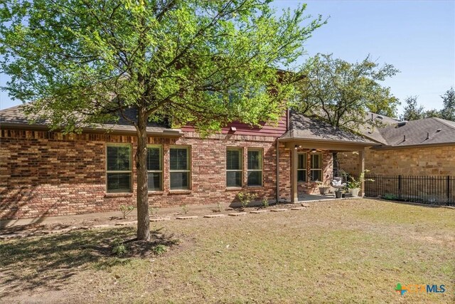 9550 Savannah Ridge Dr Unit 11, Austin, TX 78726 - rear view of house featuring brick siding and a patio area